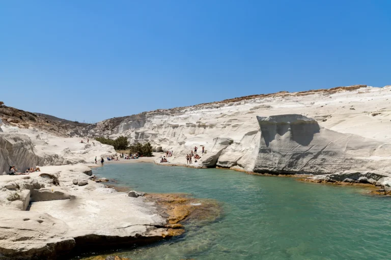 The white volcanic moonscape of Sarakiniko beach in Milos with its narrow turquoise inlet